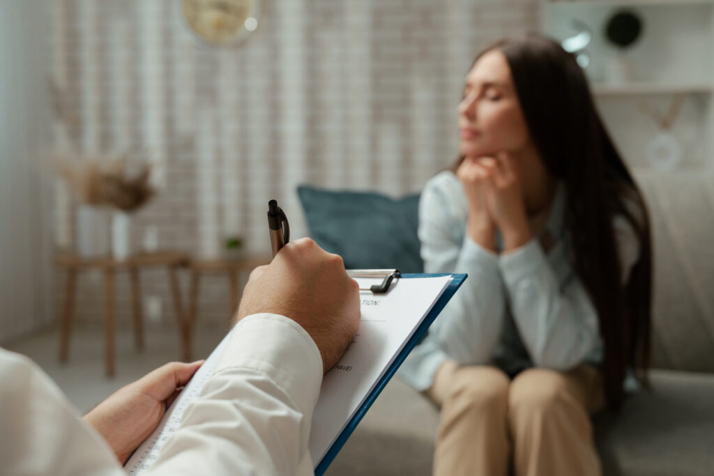 A patient having a supportive conversation with a mental health provider during an anxiety screening in a clinical setting.