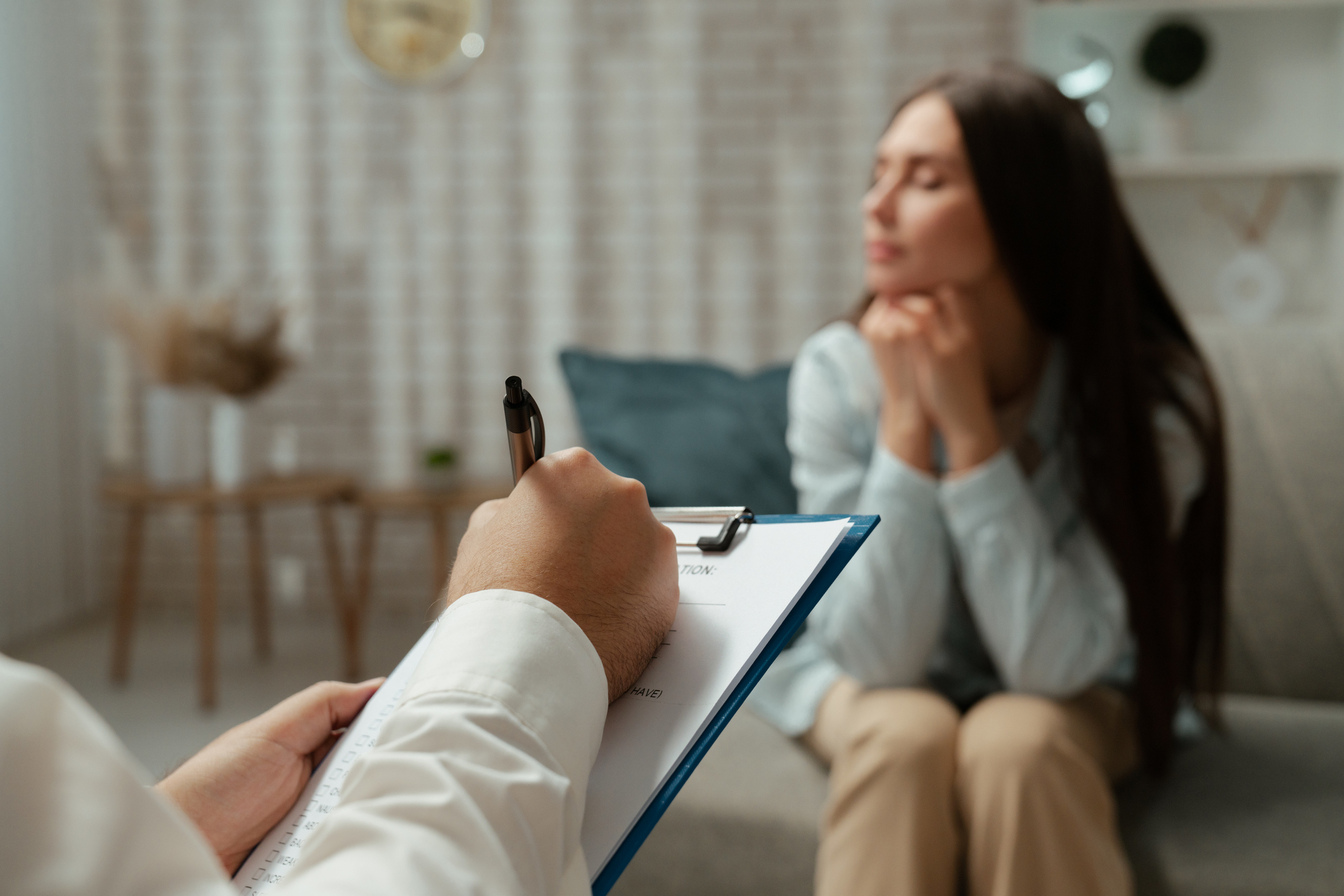 A patient having a supportive conversation with a mental health provider during an anxiety screening in a clinical setting.