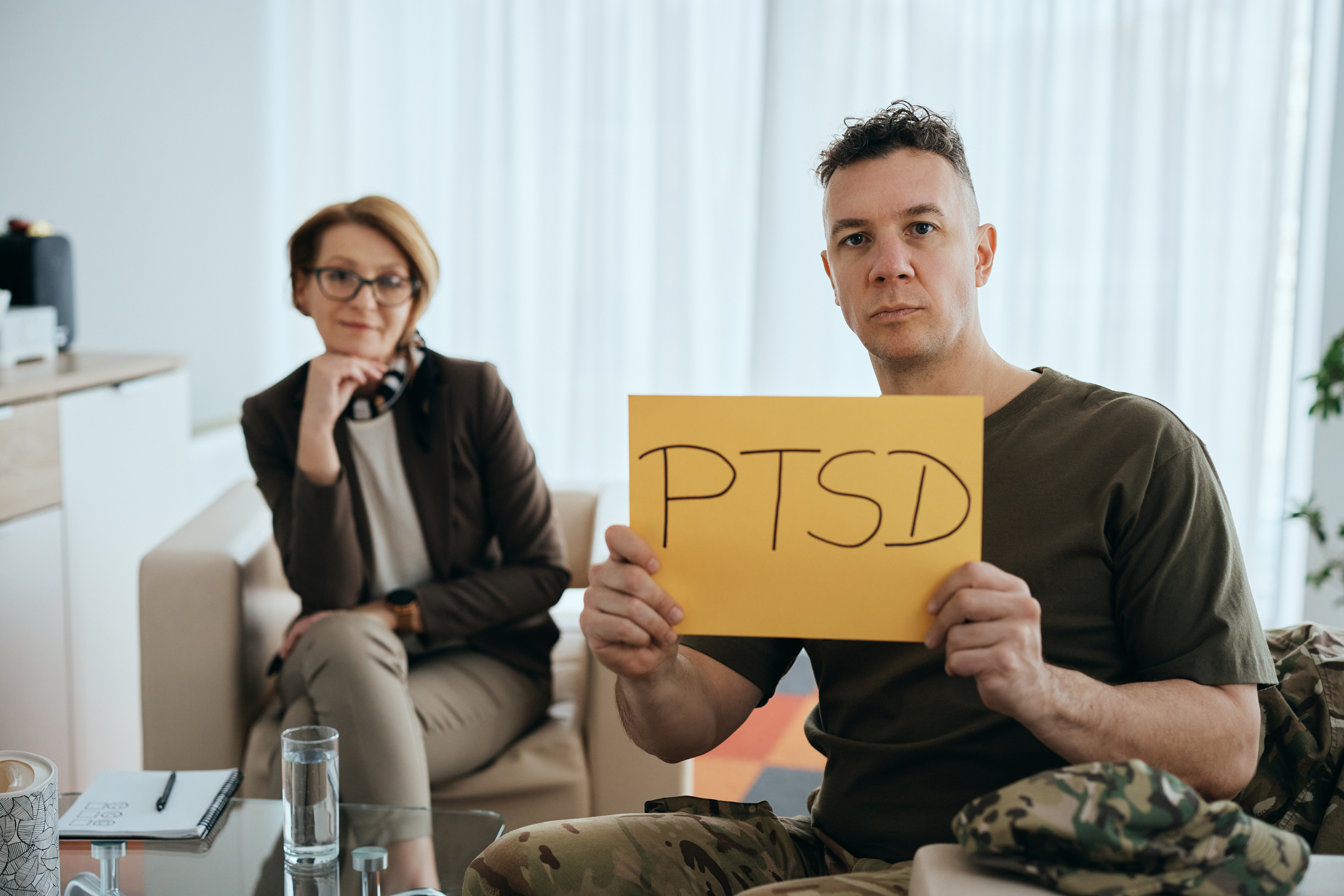 A patient and therapist discussing a personalized, integrative PTSD treatment plan in a calming clinical environment
