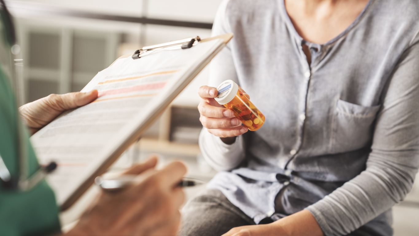 A doctor discussing psychiatric medication management with a patient in a clinical setting