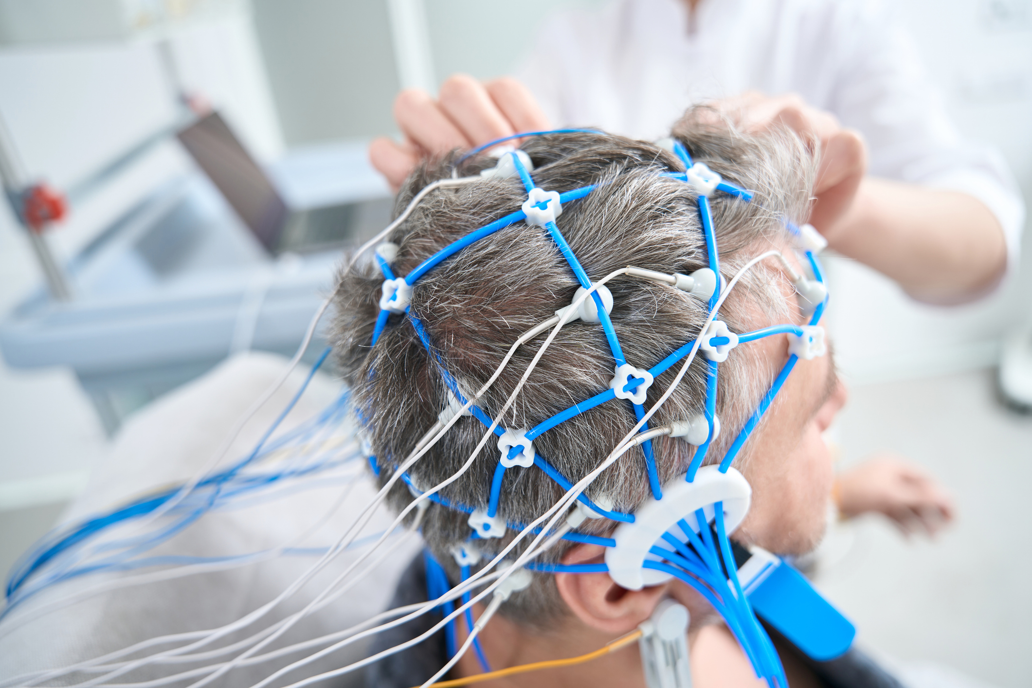 A medical professional administering clinical TMS therapy to a patient in a safe, controlled outpatient environment